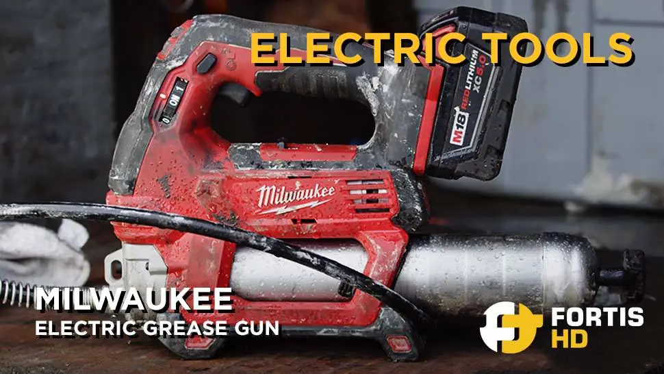 A Milwaukee electric grease gun lays on a table.